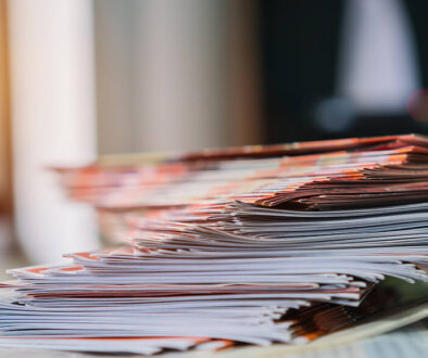 A stack of magazines with a blurry background.
