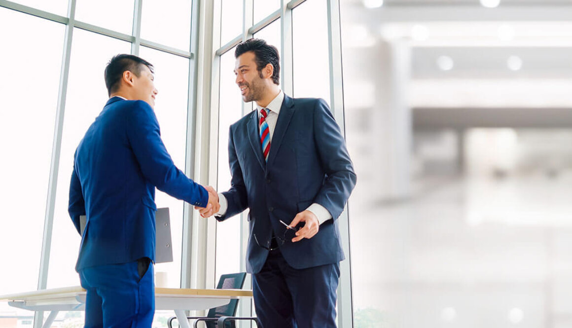 Two business men shaking hands.