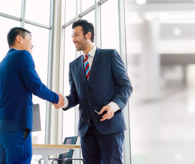 Two business men shaking hands.