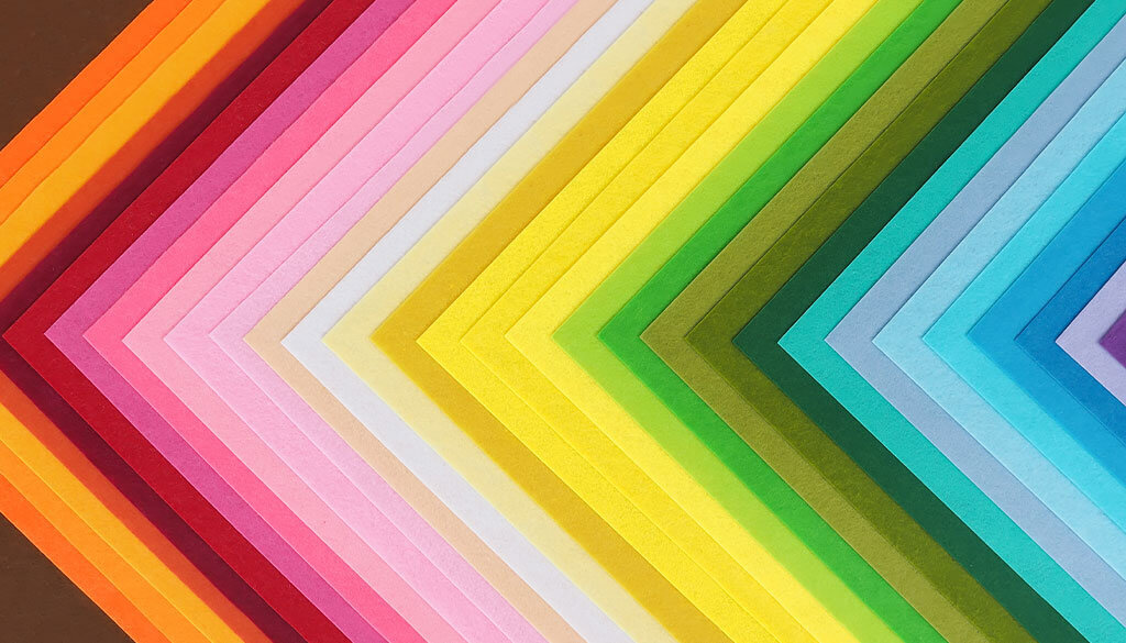Decorative paper layout in a triangle pattern showing off different colours.