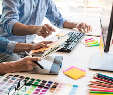 Creative desk with people looking at colour swatches.